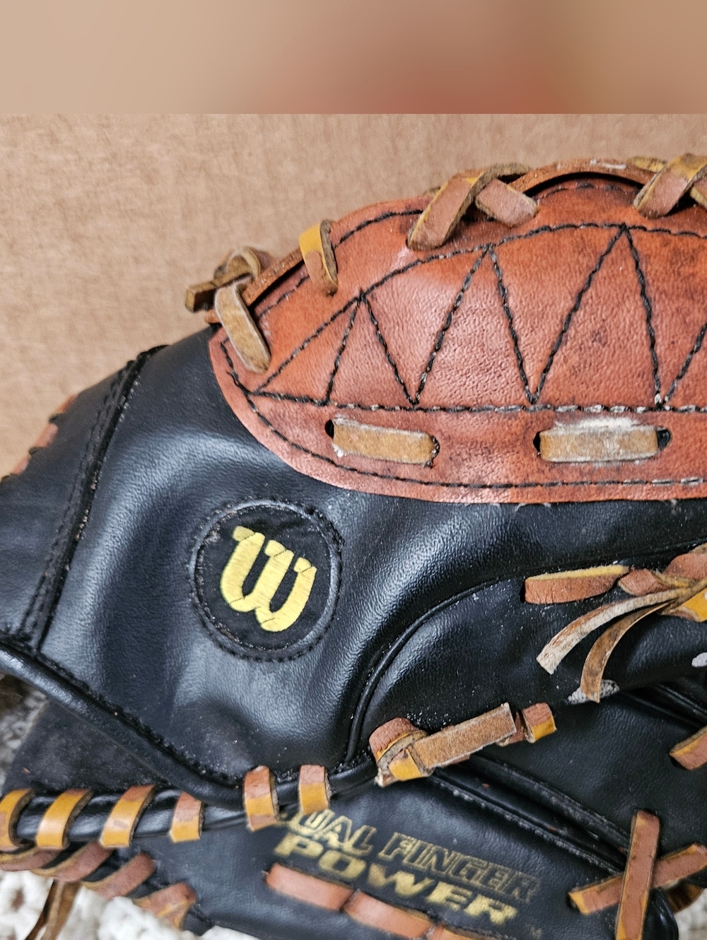 Baseball Glove Wilson Black and Brown Two-Tone Leather with Yellow Logo